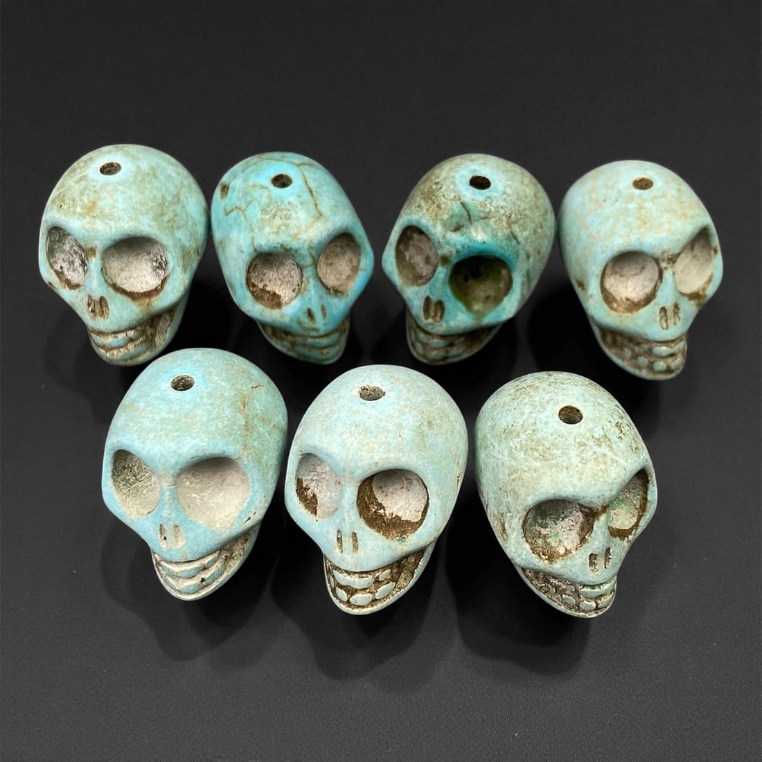 Vintage Tibetan Turquoise Skull Beads, Set of Four, c. Mid-20th Century, 1.8cm: This striking set of turquoise-carved skull beads, originates from Tibet and dates to the mid-20th century. Finely shaped and perforated for stringing, each bead represents a human skull, a motif rich