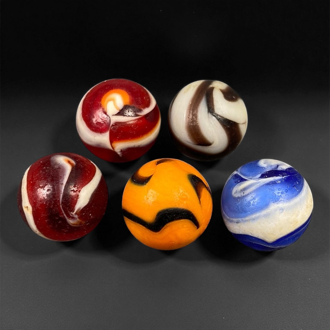 Vintage Glass Marbles Lot, Mid-20th Century, 1.5cm: This charming lot of vintage glass marbles, dating from the mid-20th century, reflects the artistry and playfulness of early handmade and molded glass craftsmanship. These marbles were produced during