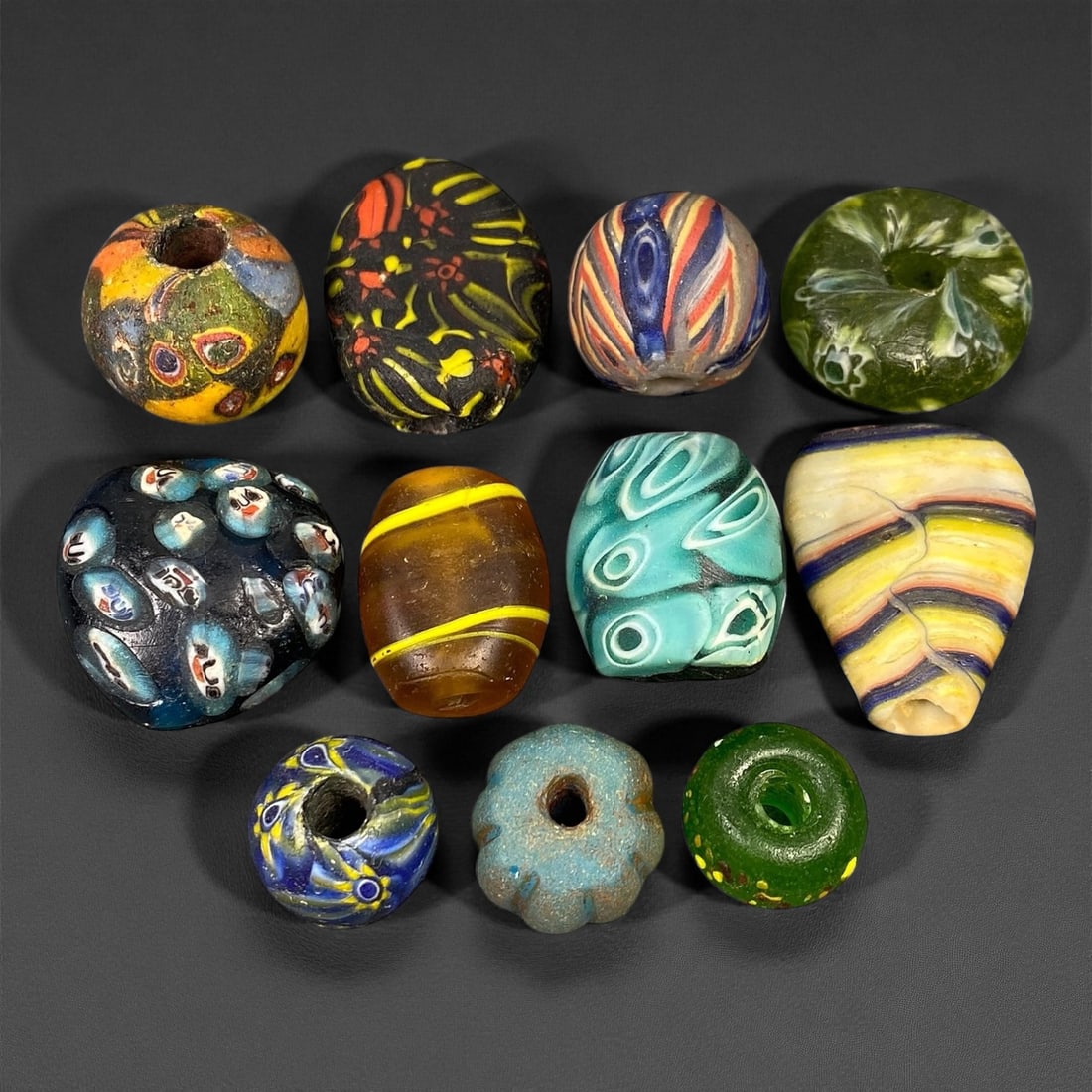 Antique Venetian Polychrome Millefiori and Chevron Glass Beads, c. 19th Century, 1.6-3.1cm: This lively assemblage of antique Venetian glass beads, dating from the 19th century, captures the exuberant color and artistry that made Murano glassmakers the undisputed masters of decorative beadwo