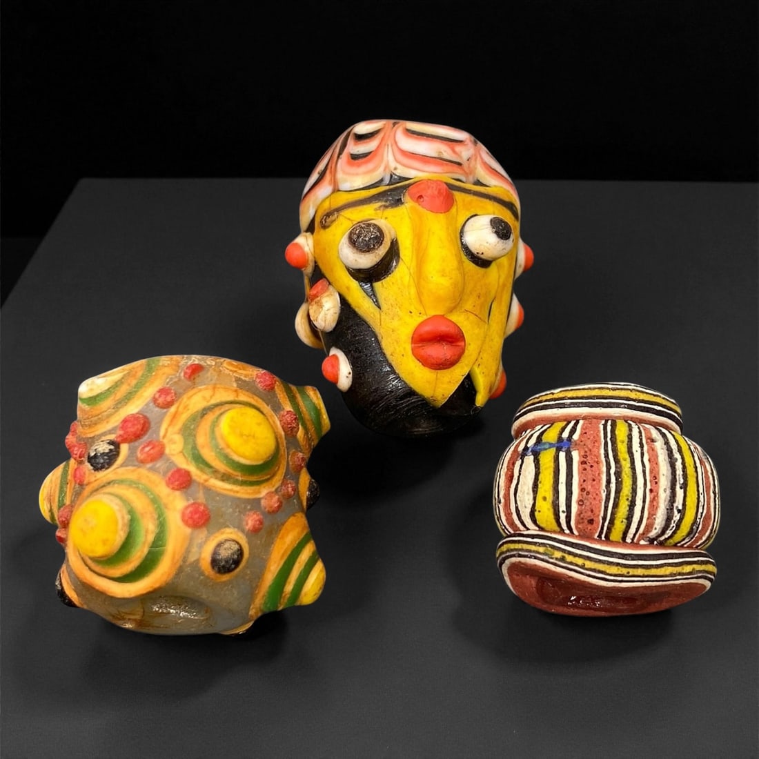 Ancient Majapahit Borneo Polychrome Glass Trade Beads, c. 13th-16th Century CE, 1.5-2.5cm: These vibrant polychrome glass trade beads date to the Majapahit period of Southeast Asia, between the 13th and 16th centuries CE. Crafted with exquisite layered glasswork, each bead showcases intrica