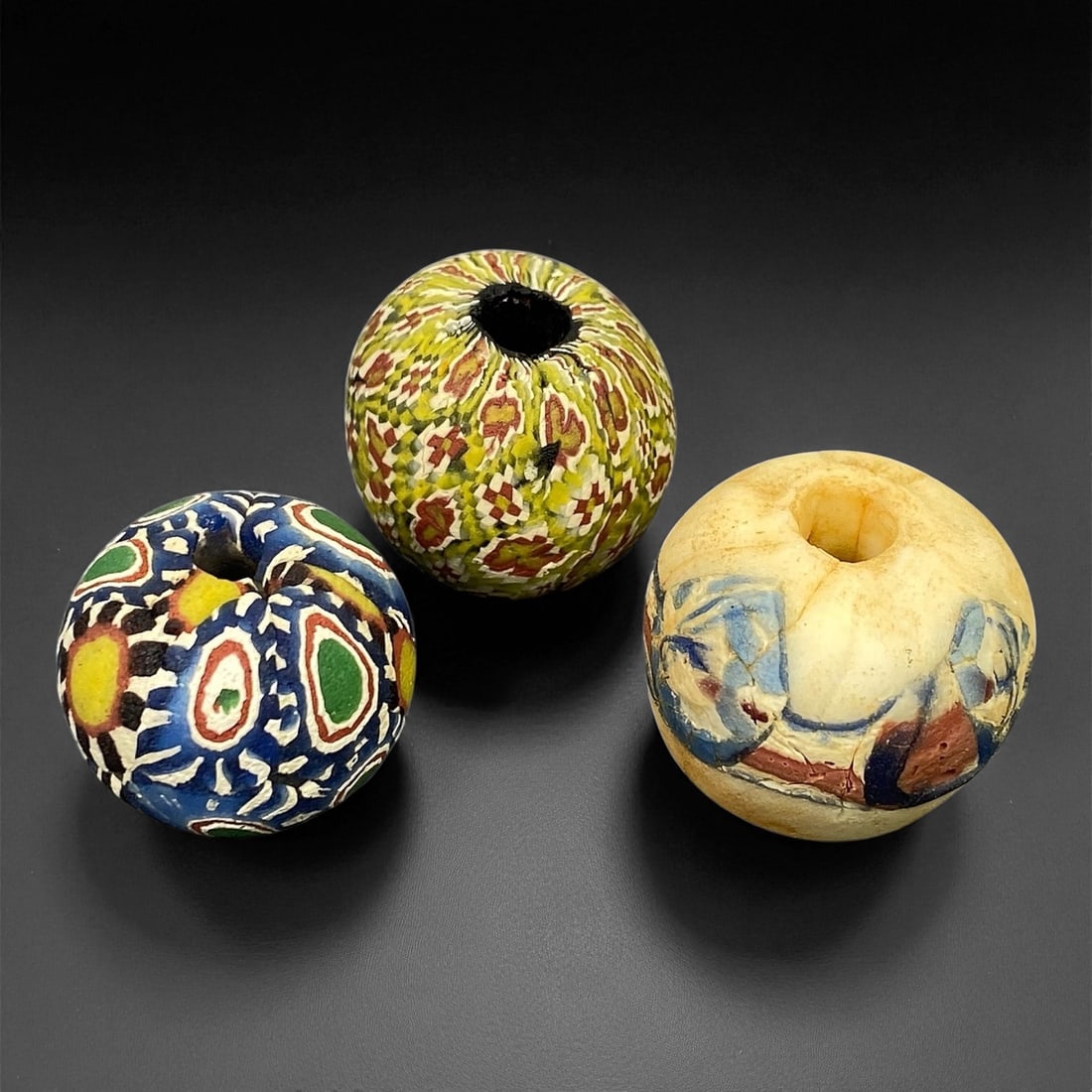 Ancient Majapahit Borneo Polychrome Glass Trade Beads, c. 13th-16th Century CE, 1.7-2cm: These vibrant polychrome glass trade beads date to the Majapahit period of Southeast Asia, between the 13th and 16th centuries CE. Crafted with exquisite layered glasswork, each bead showcases intrica