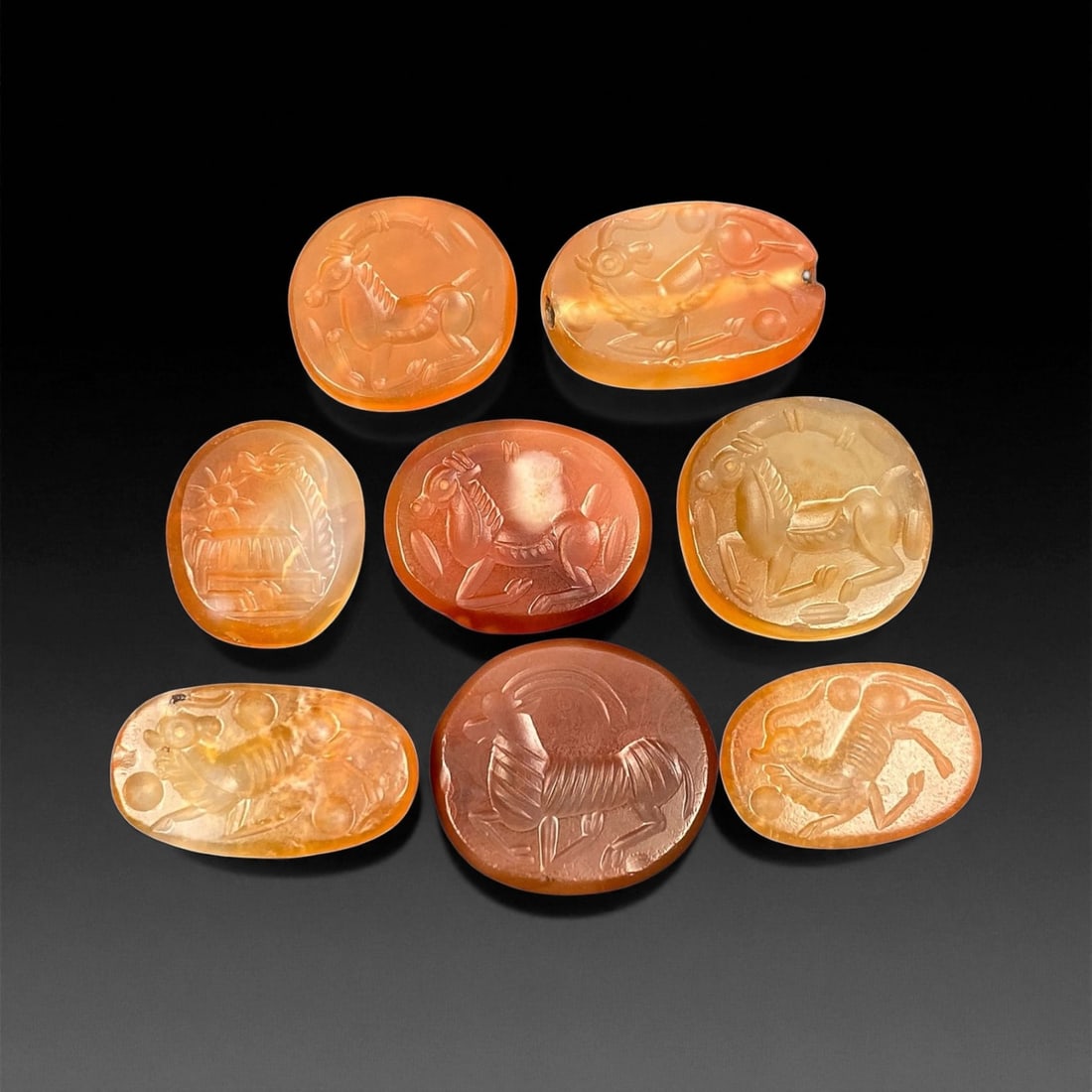 Ancient Sasanian Carnelian Mythic Creatures Intaglio Seals, c. 3rd-6th Century CE, 1.8-2.2cm: This refined group of ancient Sasanian carnelian intaglio seals dates from the 3rd-6th century CE, during the height of the Sasanian Empire. Each gem is delicately carved with stylized depictions of a