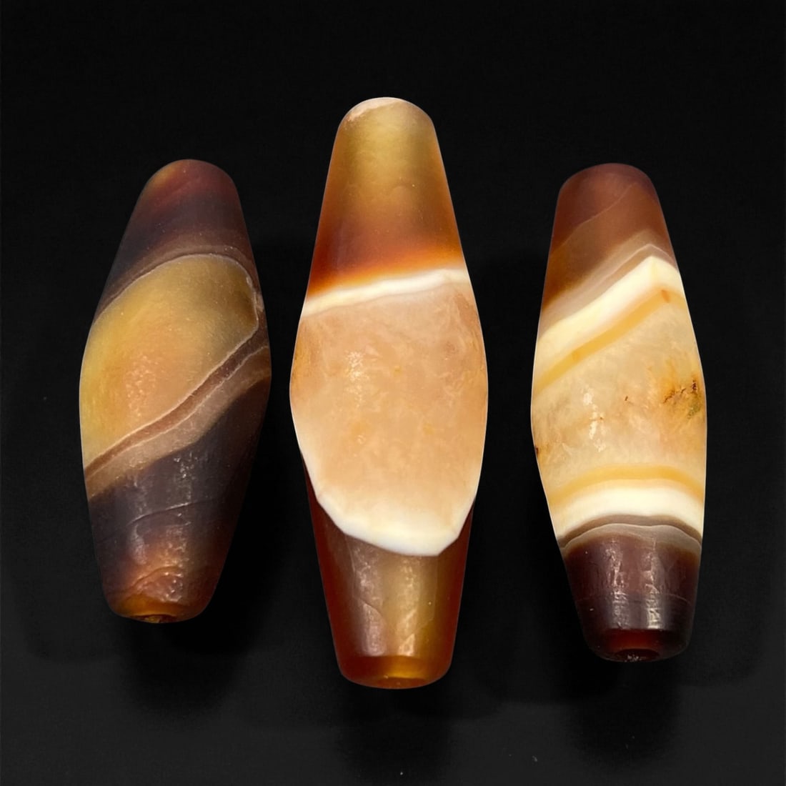Ancient Persian Banded Agate Barrel Beads, c. 5th-3rd Century BCE, 3.1-4.1cm: These elegant ancient Persian agate beads date to the Achaemenid to early Parthian period, circa 5th-3rd century BCE. Expertly shaped into elongated barrel forms, each bead displays the natural bandin