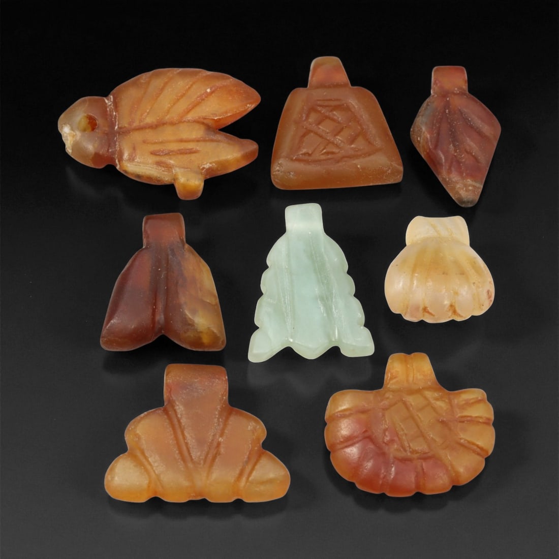 Ancient Coptic Egyptian Carnelian Amulet Set, c. 4th-7th Century CE, 1.5-2.2 cm: This ensemble of carved carnelian amulets represents the refined spiritual craftsmanship of the Coptic Egyptian era, c. 4th-7th century CE. Each miniature pendant embodies protective symbolism deeply 