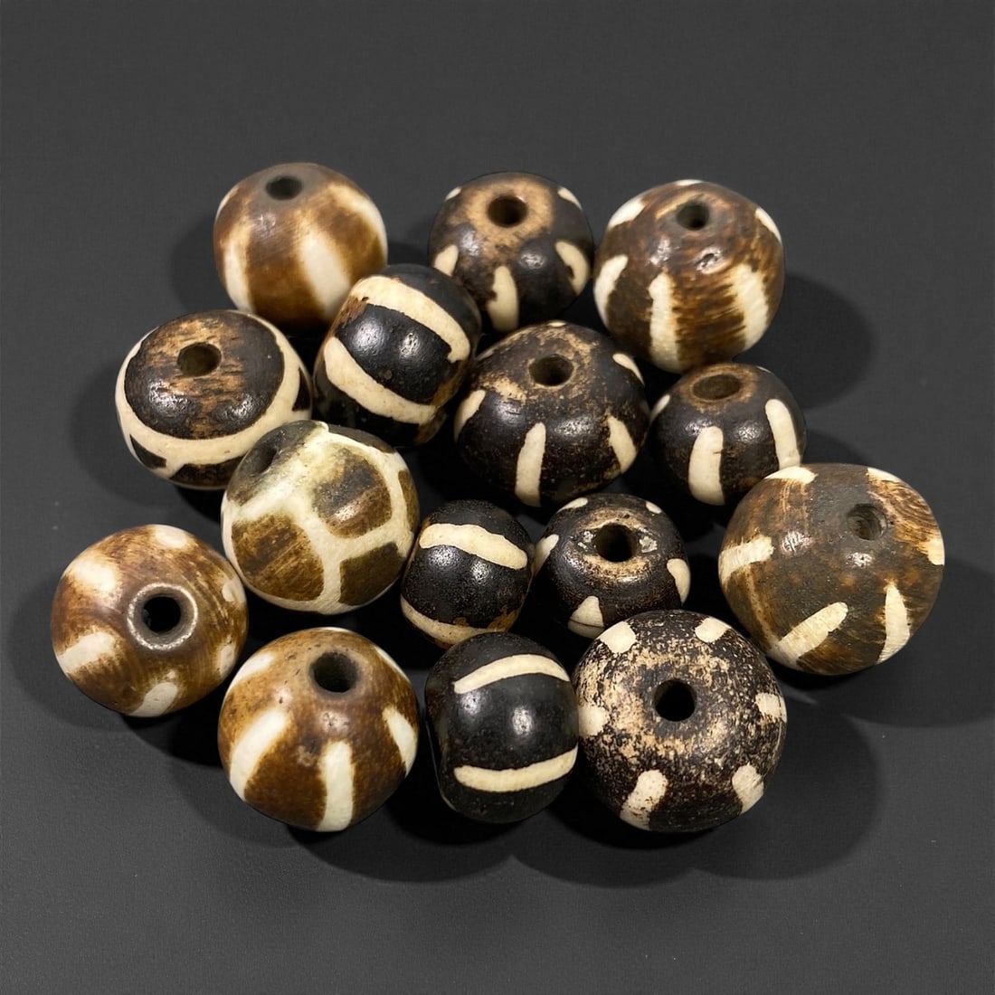 Antique Burmese Pumtek Pyu-Style Patterned Wood Beads, c. 19th Century, 1-1.3cm: These striking antique Pumtek beads originate from Burma (modern-day Myanmar) and date to the 19th century. Crafted from palm wood, they are decorated in the traditional Pyu-style etched pattern, an a