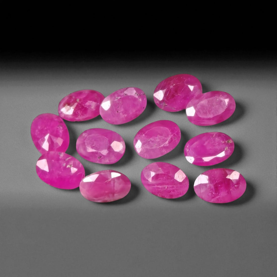 5.87 Carats Vivid Pinkish Red Ruby Oval Lot - Natural Mozambique Stones: This lively lot of ruby ovals glows with an intense pinkish-red tone that captures the eye with warmth and vibrancy. Each gem, measuring approximately 5.6x4.0x2.3mm, reveals a balance of medium to dee