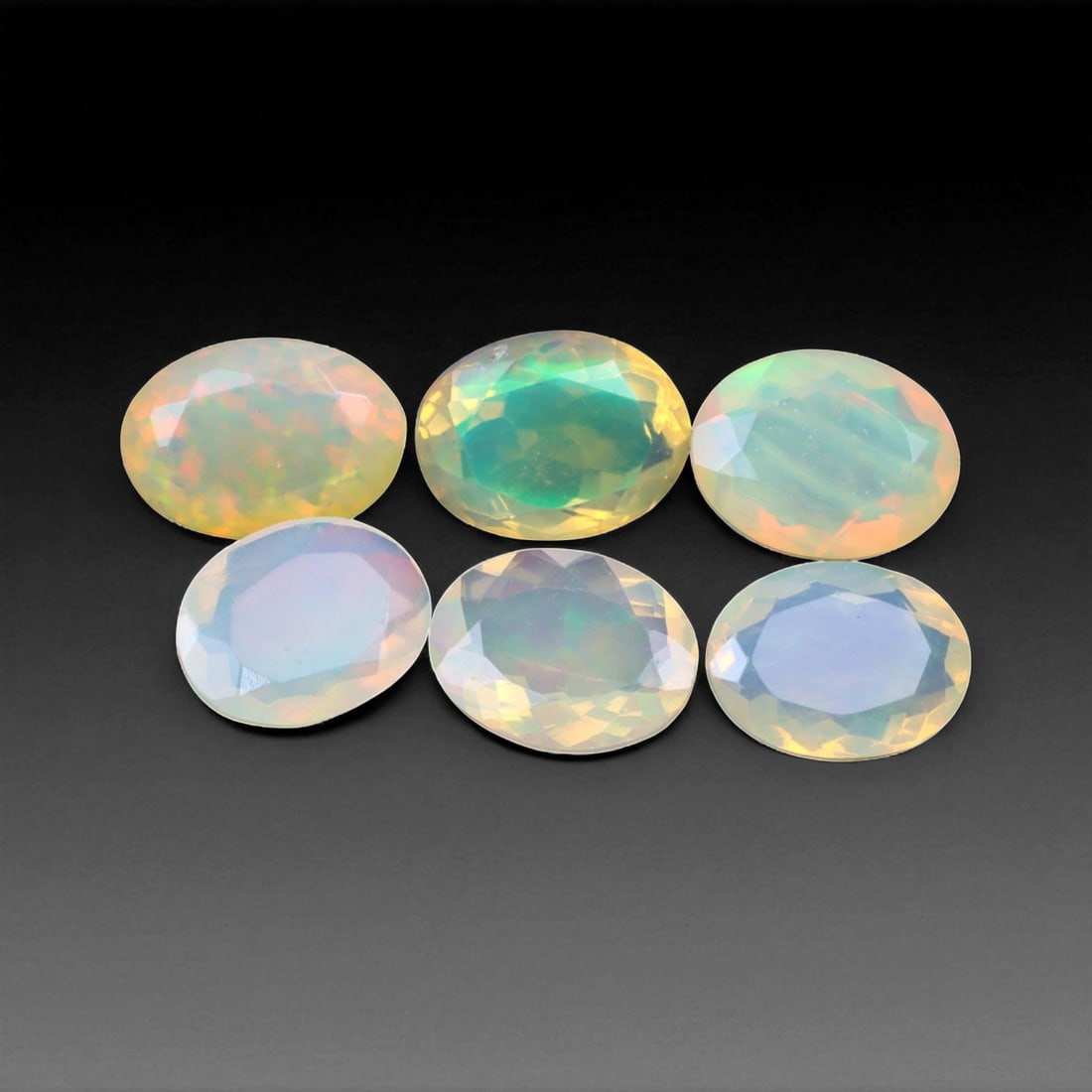 7.51 Carats Faceted Welo Opal - Natural Ethiopian Stone: This graceful 9x7x3 mm Ethiopian opal radiates a soft yet vibrant play-of-color, with hues of green, orange, and rose blending harmoniously beneath its faceted surface. The gem displays a fluid mosaic