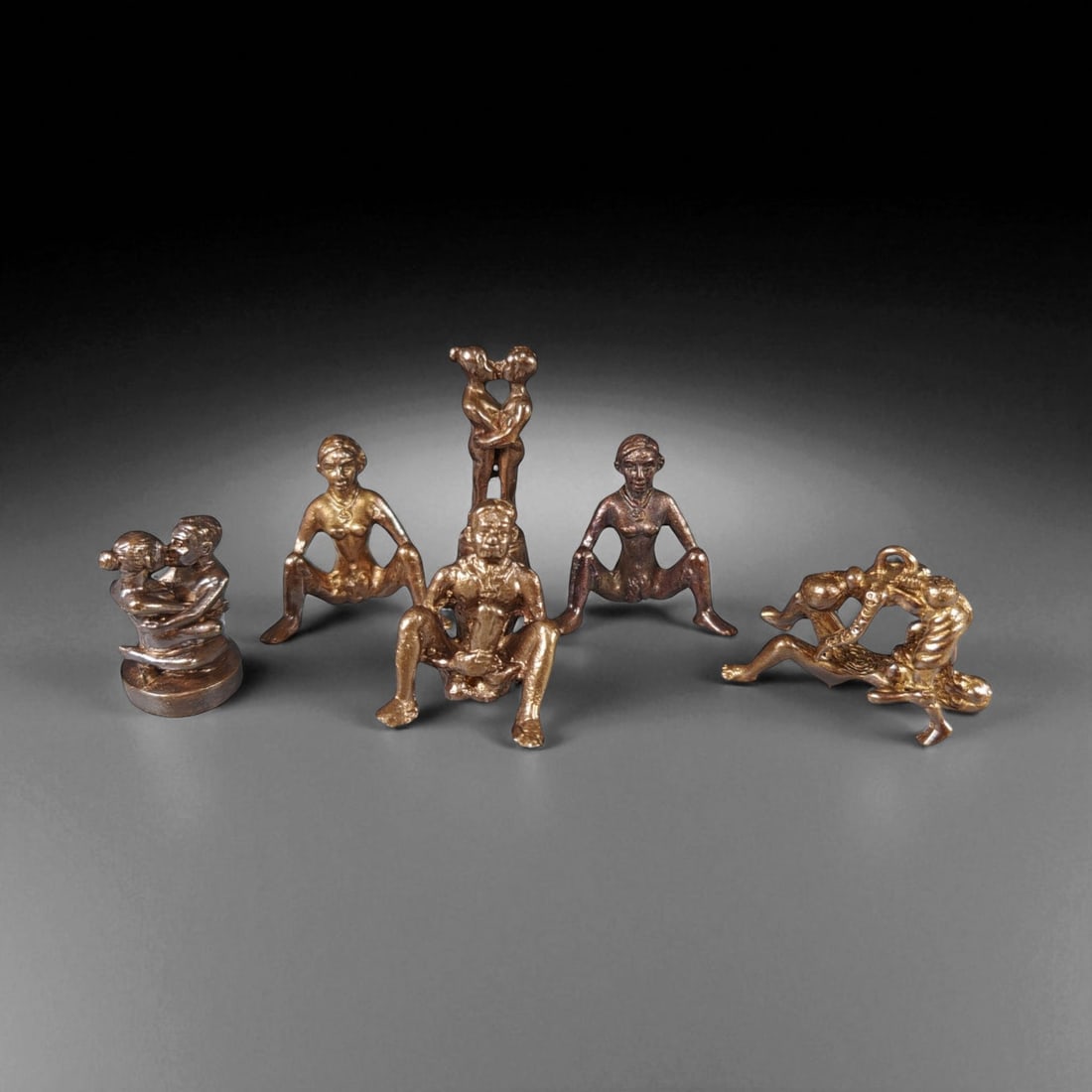 Vintage Thai Brass Fertility and Harmony Talismans Set, c. Mid-Late 20th Century 2-3.5cm: This remarkable set of six vintage Thai brass talismans, dating from the mid to late 20th century, represents traditional fertility and harmony charms that have long held a place in Thai spiritual and