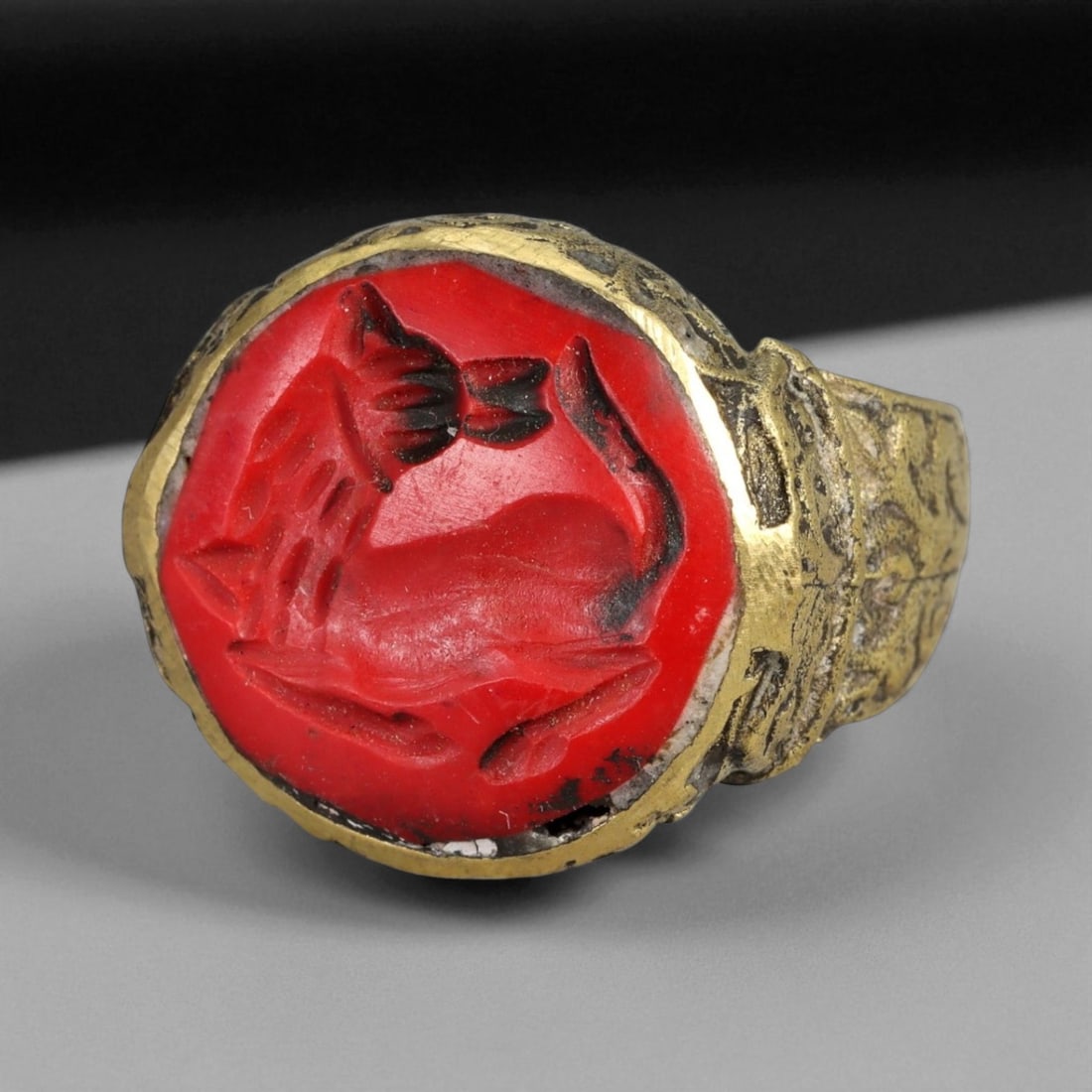 Antique Qajar Gold Gilt Intaglio Signet Ring, c. 19th-20th Century, 7.5 US: This substantial gilt ring, dating to the Qajar era of the 19th-20th century, embodies the regal aesthetic and cultural refinement of Persian jewelry traditions. The bezel is set with an engraved inta