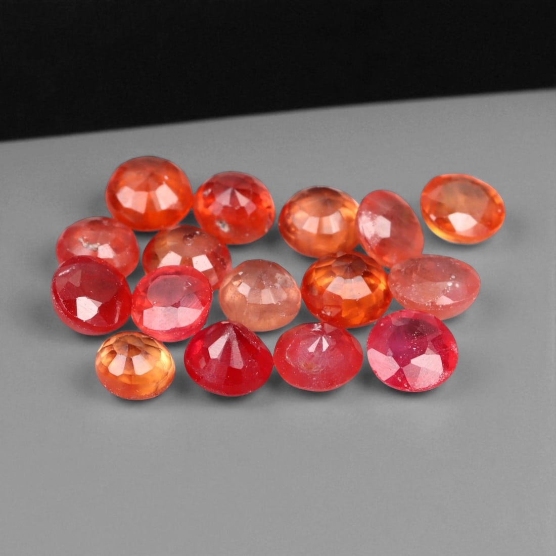 3.31 Carats Fiery Orange Faceted Sapphire Parcel - Natural Sri Lankan Stones: This lively parcel of faceted sapphires radiates with a vivid medley of orange, reddish-orange, and warm coral hues. Each gem, averaging 3.4x2.4 mm, captures light with a brilliant internal glow, enha