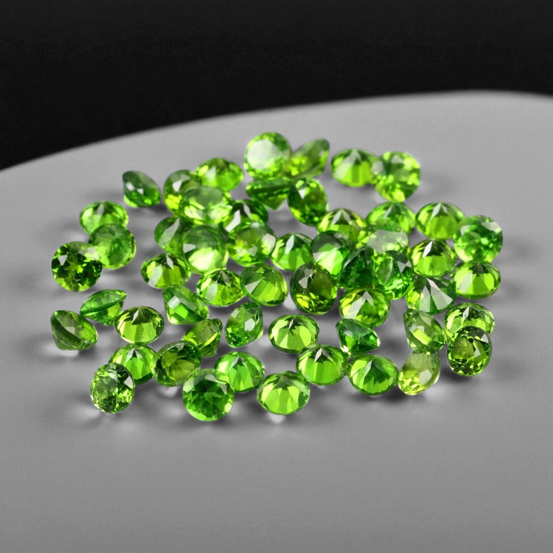 3.99 Carats Vivid Green Faceted Chrome Diopside Parcel - Natural Russian Stones: This dazzling parcel of chrome diopside gems glows with an intense forest-green hue, alive with clarity and brilliance. Each round faceted stone, averaging 2.6x1.6 mm, reflects light with crisp precis