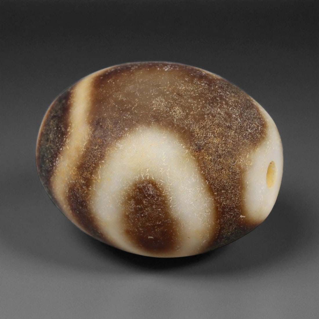 Antique Tibetan Etched Dzi Bead, 19th-20th Century, 2cm: Dzi beads are among the most iconic and revered forms of Tibetan adornment, prized not only for their striking appearance but also for their deep cultural and spiritual associations. Traditionally fas