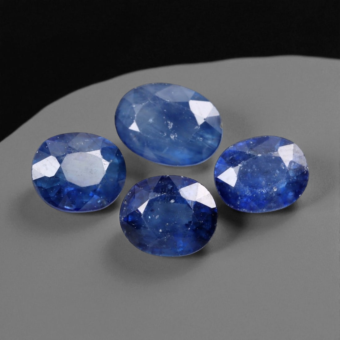 4.07 Carats Royal Blue Sapphire Oval Lot - Natural Ceylon Stones: This captivating lot of oval-cut sapphires exhibits a deep royal blue color, rich and even, with flashes of lighter brilliance across the facets. Each stone, measuring approximately 6x5x3mm, is gracef
