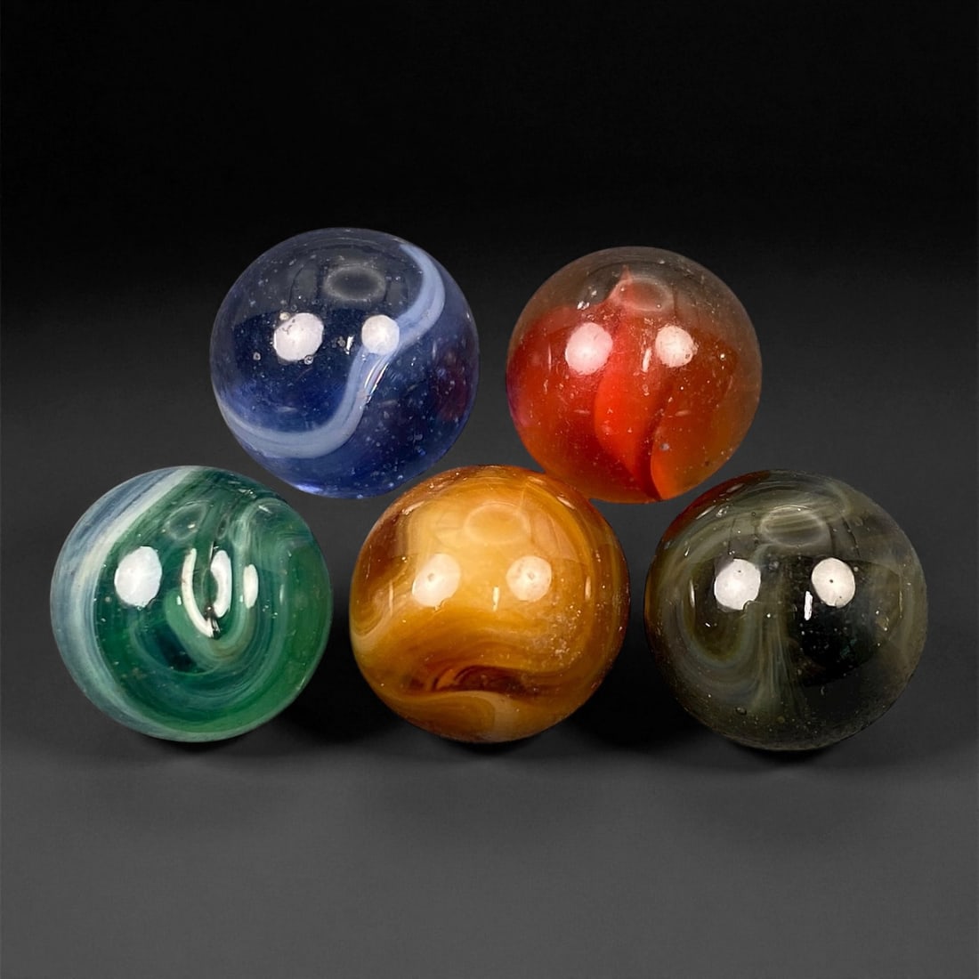 Vintage Glass Marbles Lot, Mid-20th Century, 1.4-1.5cm: This charming lot of vintage glass marbles, dating from the mid-20th century, reflects the artistry and playfulness of early handmade and molded glass craftsmanship. These marbles were produced during
