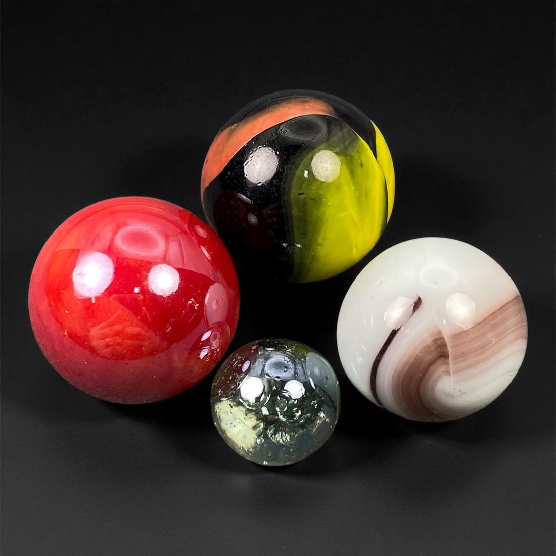 Vintage Glass Marbles Lot, Mid-20th Century, 1.5-2.5cm: This charming lot of vintage glass marbles, dating from the mid-20th century, reflects the artistry and playfulness of early handmade and molded glass craftsmanship. These marbles were produced during