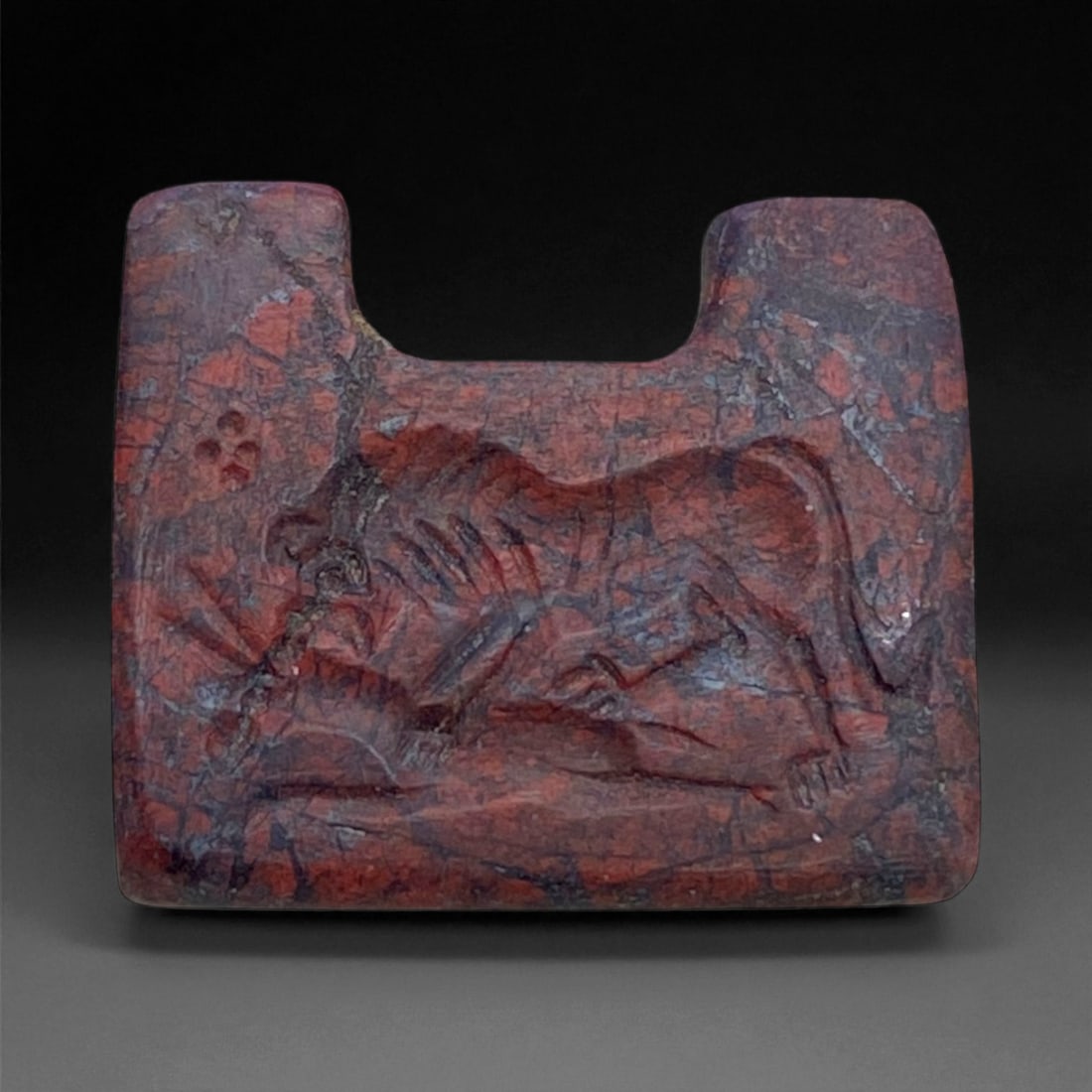 Ancient Near Eastern Jasper Lion Hunt Amulet, c. 1200-800 BCE, 2cm, 6g: This finely carved red jasper amulet, dating to the Late Bronze to Early Iron Age (c. 1200-800 BCE), captures the vigor and symbolism of the lion hunt-a motif deeply rooted in the art and mythology of
