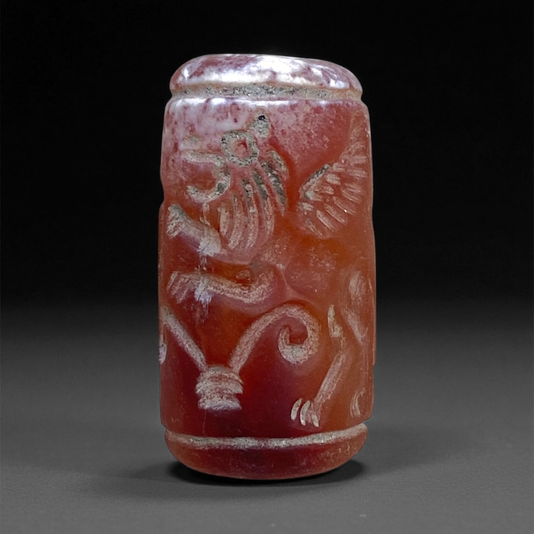 Ancient Achaemenid Persian Carnelian Cylinder Seal, c. 6th-4th Century BCE, 2.5cm, 9g: This finely engraved carnelian cylinder seal dates to the Achaemenid Persian Empire (c. 6th-4th century BCE), an era celebrated for its artistic synthesis of Mesopotamian tradition and imperial grande