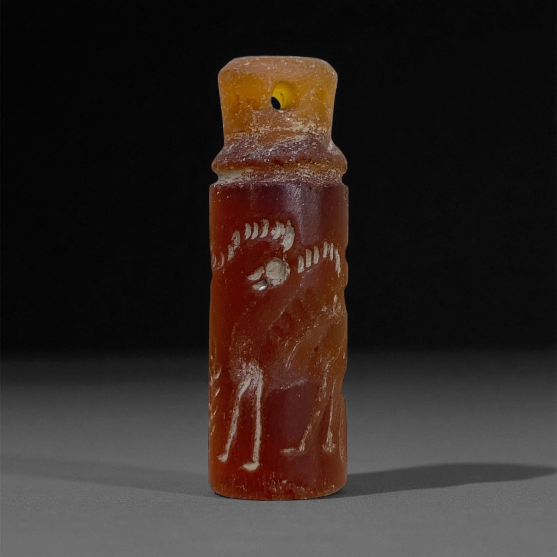 Ancient Elamite Carnelian Cylinder Seal with Ibex Motif, c. 2000-1500 BCE, 2.5cm, 3g: This elegant carnelian cylinder seal, dating from the Middle Elamite period (c. 2000-1500 BCE), exemplifies the refined artistry of southwestern Iran during one of its most culturally vibrant eras. Fi
