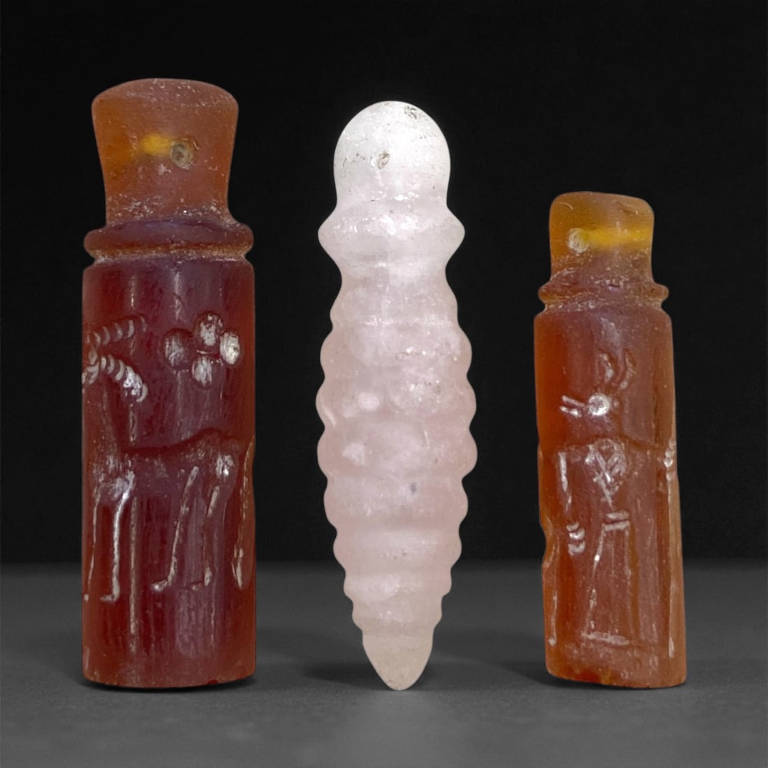 Ancient Elamite Carnelian Cylinder Seals and Quartz Amulet, c. 2nd Millennium BCE, 3.5cm, 13g: This exquisite assemblage of three small yet profoundly symbolic artifacts originates from ancient Elam (southwestern Iran), a civilization flourishing contemporaneously with early Mesopotamia during 