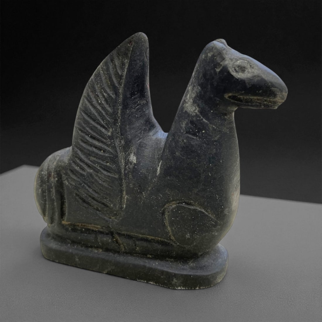Ancient Indo-Parthian Mythical Winged Horse Figurine in Schist, c. 1st Century CE, 6cm, 141g: This finely carved stone figurine depicts a stylized mythical winged horse, its powerful stance and exaggerated features reflecting both imaginative flair and symbolic intent. Originating from the Ind