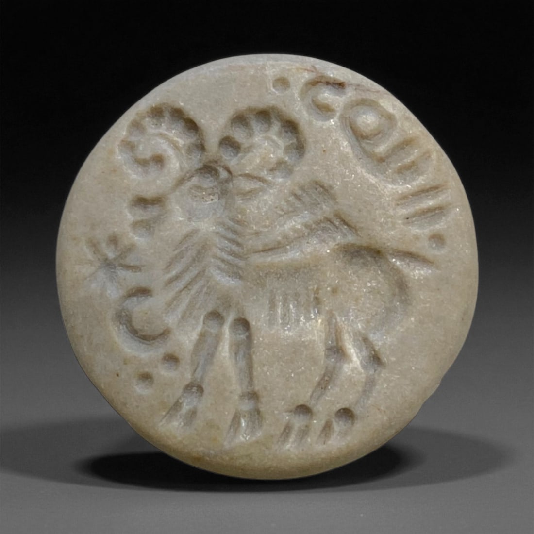 Ancient Achaemenid Hemispherical Stamp Seal with Winged Lion, c. 6th-4th Century BCE, 2cm, 10g: This elegant hemispherical stamp seal, carved from soft beige stone, originates from the Achaemenid Persian Empire during its height between the 6th and 4th centuries BCE. The engraved surface feature