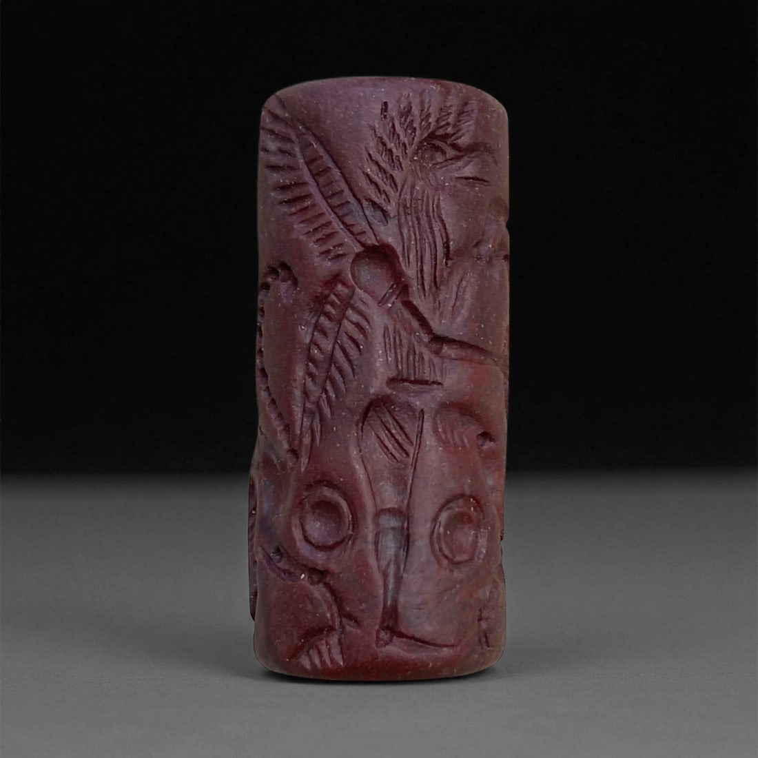 Ancient Akkadian Winged Deity Jasper Cylinder Seal, c. 23rd-22nd Century BCE, 3.5cm, 15g: This striking cylinder seal, carved from deep reddish jasper, dates to the Akkadian Empire (c. 2334-2154 BCE)-one of humanity's earliest great empires and a defining era in the history of Mesopotamian
