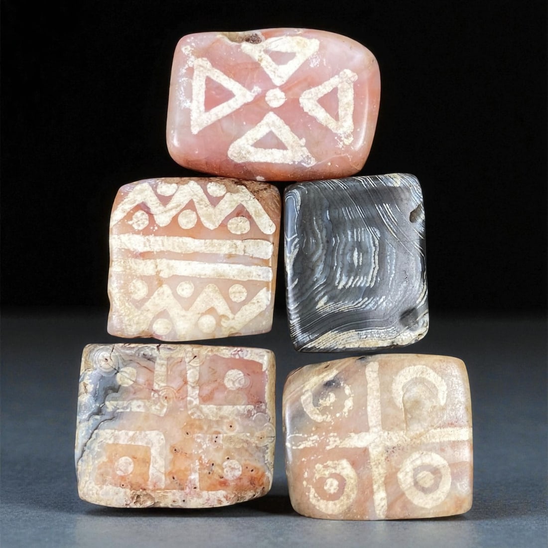 Ancient Indo-Himalayan Silk Road Trade Carnelian Beads, c. 8th-12th Century CE, 2-2.7cm: This fine group of five ancient etched carnelian beads originates from the Indo-Himalayan region, dating to the 8th-12th century CE. Each bead is fashioned into a square or rectangular form, with geom