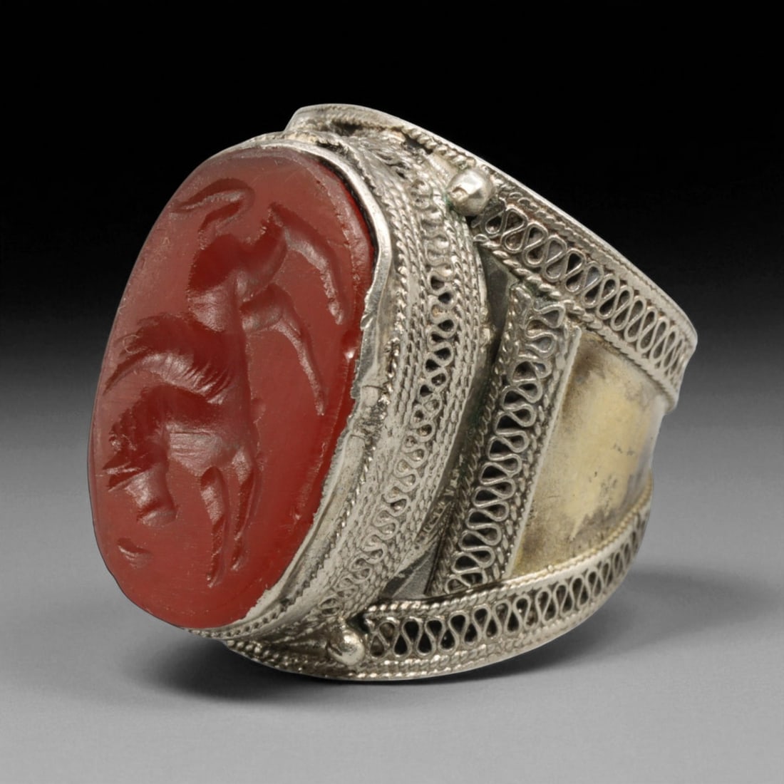 Antique Central Asian Carnelian Intaglio Silver Ring, c. 19th-20th Century, US 8: This distinguished antique ring captures the regal essence of Central Asian artistry, featuring an oval carnelian intaglio finely engraved with a lion motif - a timeless emblem of strength, nobility,