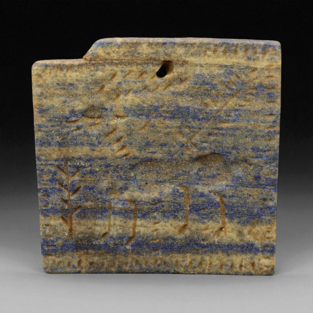 Ancient Neo-Sumerian Lapis Lazuli Hunting Scene Plaque, c. 21st Century BCE, 10 cm: This exceptional lapis lazuli plaque, measuring 10 cm, dates to the Neo-Sumerian period (c. 21st century BCE), during the Third Dynasty of Ur. Finely incised upon the mottled blue and gold stone surfa