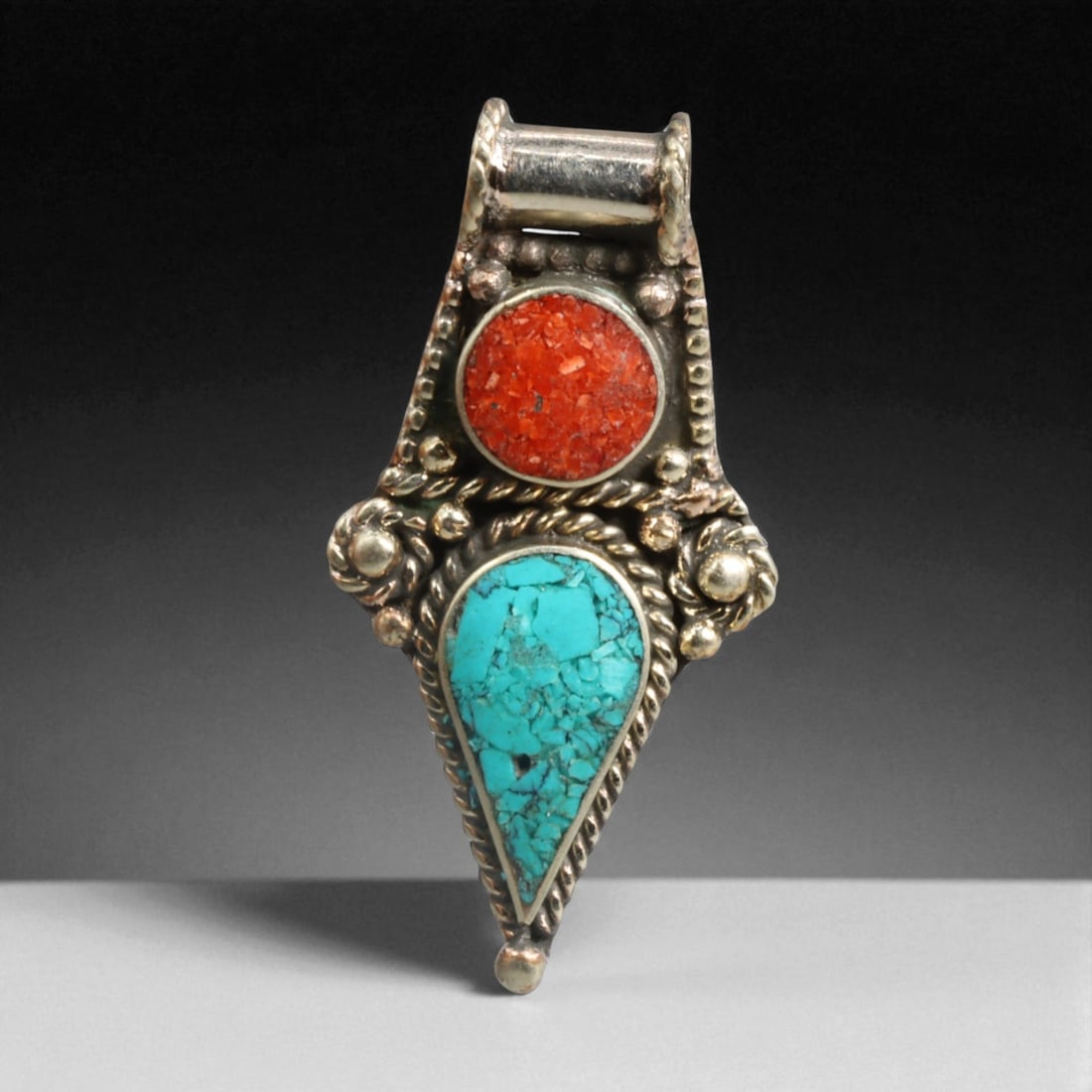 Tibetan Coral Turquoise Floral Teardrop Pendant Necklace, Himalayas Origin, 8.5g: Graceful and symbolically potent, this Tibetan pendant presents a vertically aligned dual-stone composition, uniting a circular red coral cabochon above a teardrop turquoise set in detailed silverwork