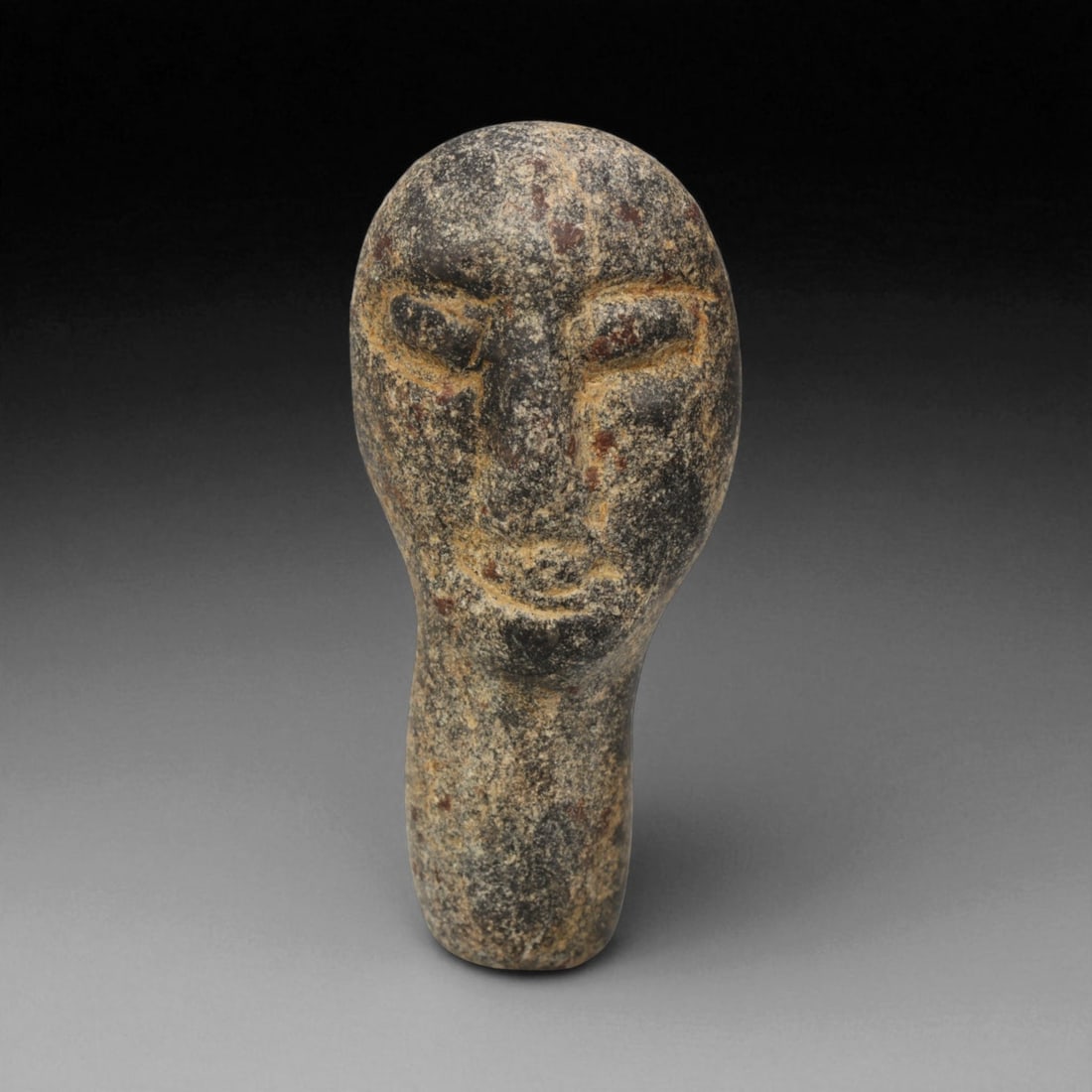 Ancient Bactrian Steatite Idol Head, c. 2nd-1st Millennium BCE, 3.7cm: This finely carved idol head, sculpted from dark steatite, originates from the ancient Bactrian civilization of Central Asia, dating to the 2nd-1st millennium BCE. Despite its compact scale, the piece