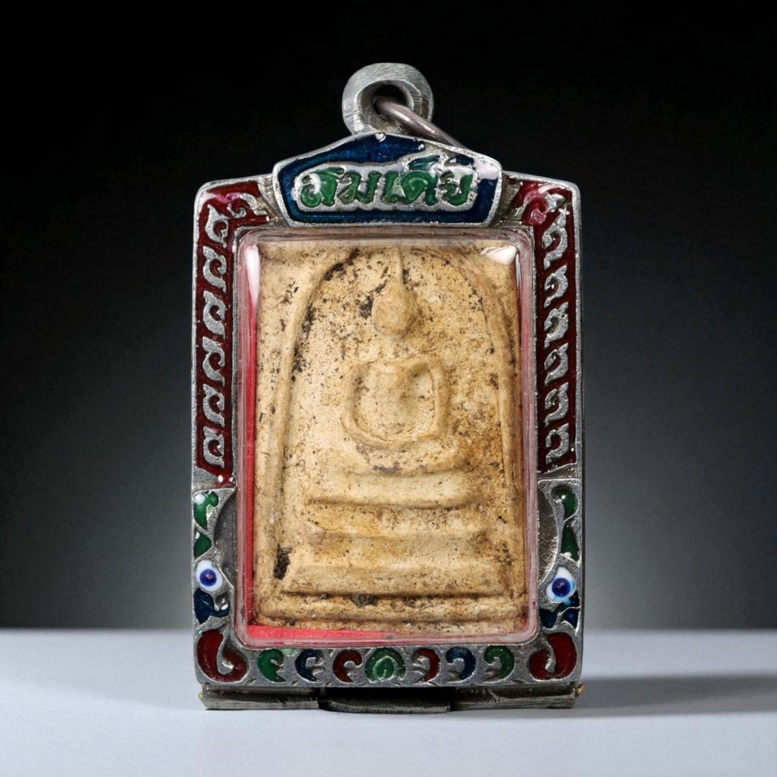 Vintage Thai Buddhist Amulet in Ornate Framed Setting, 20th Century, 6cm: This vintage Thai Buddhist amulet exemplifies the devotional artistry that continues to define Thailand's sacred craftsmanship. Encased within an intricately detailed frame, the amulet displays refine