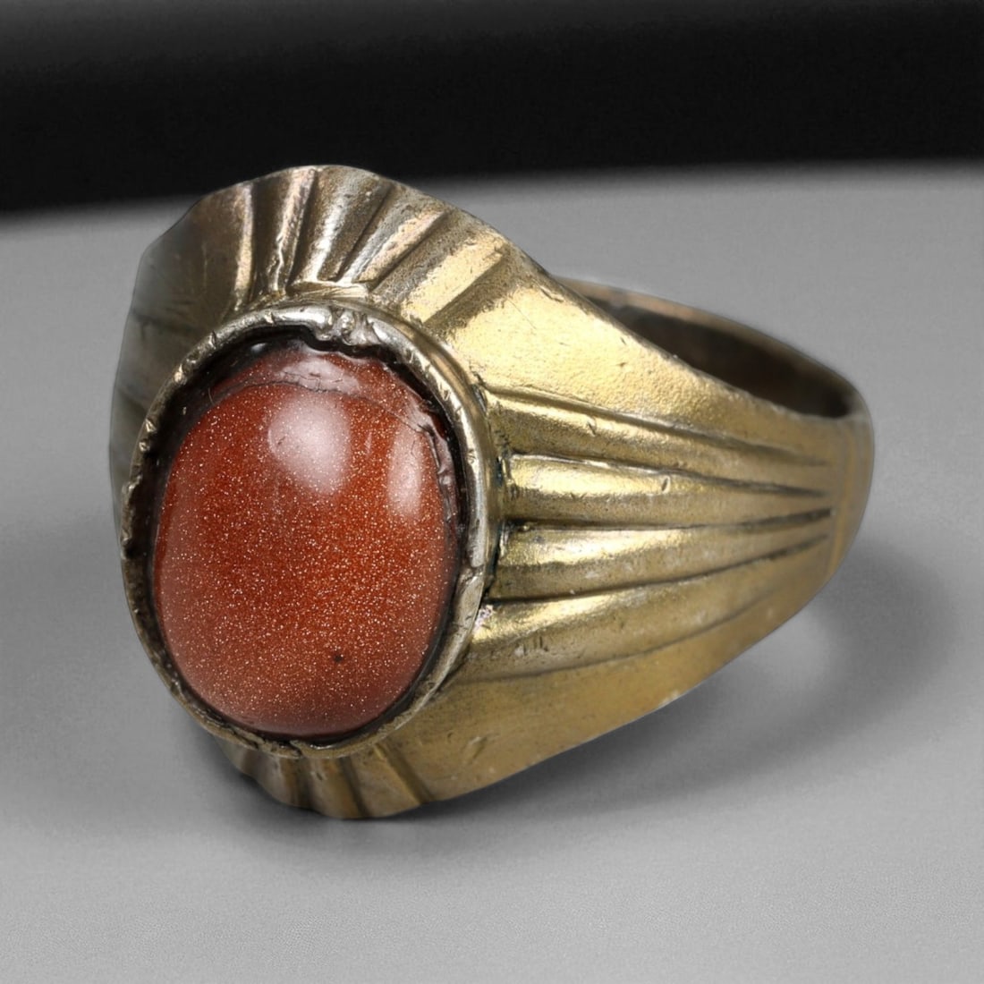 Antique Persian Goldstone Cabochon Silver Ring, c. 19th Century 6g: This antique silver ring, dating to 19th century Persia during the Qajar era, embodies both refinement and symbolic beauty. At its center lies a polished goldstone cabochon, shimmering with a natural,