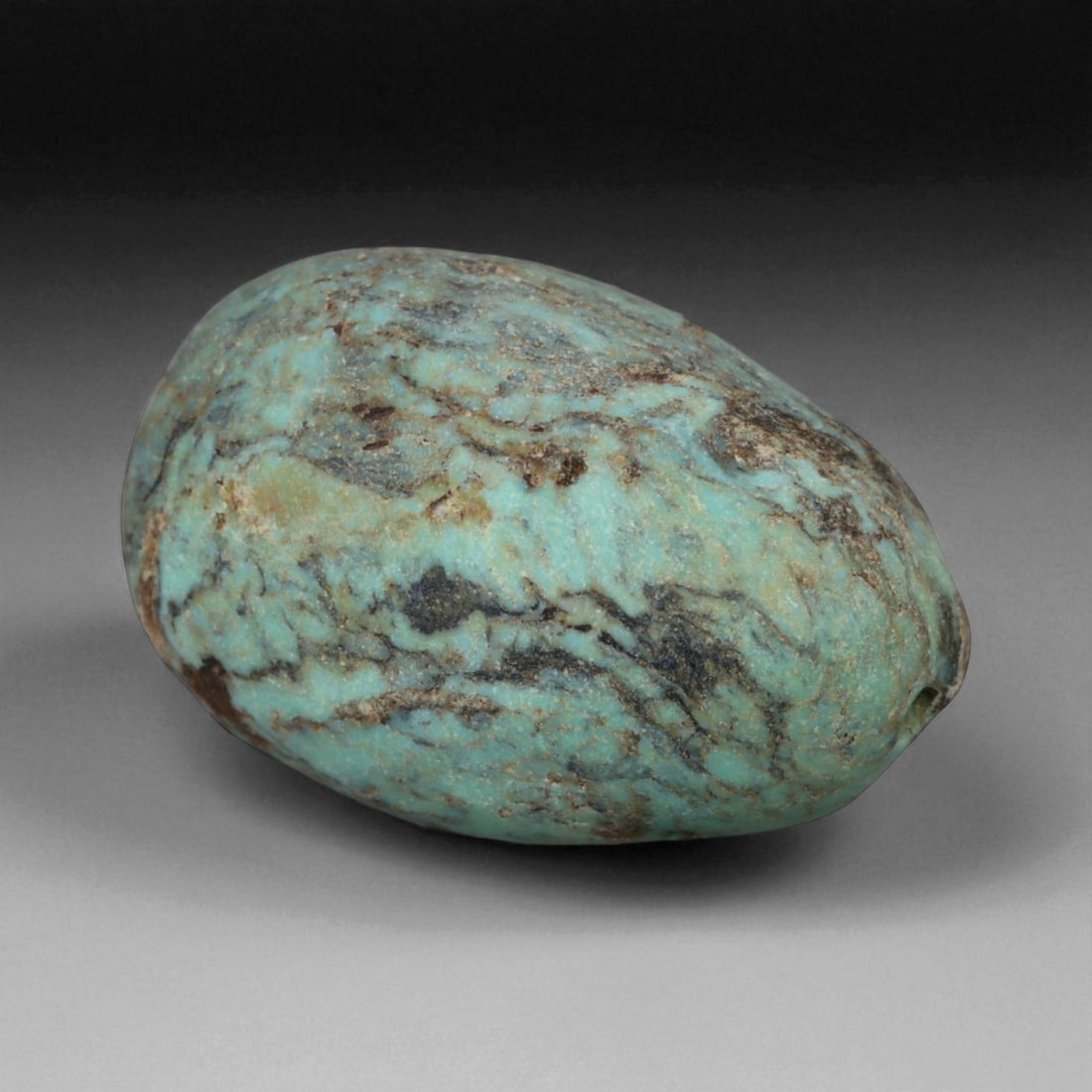 Antique Tibetan Mala Prayer Turquoise Amulet Bead, c. 18th-19th Century, 2.2cm, 6g: This striking turquoise bead from Tibet, dating to the 18th-19th century, embodies the deep spiritual and cultural reverence accorded to this precious stone in Himalayan tradition. Its organic, rounde