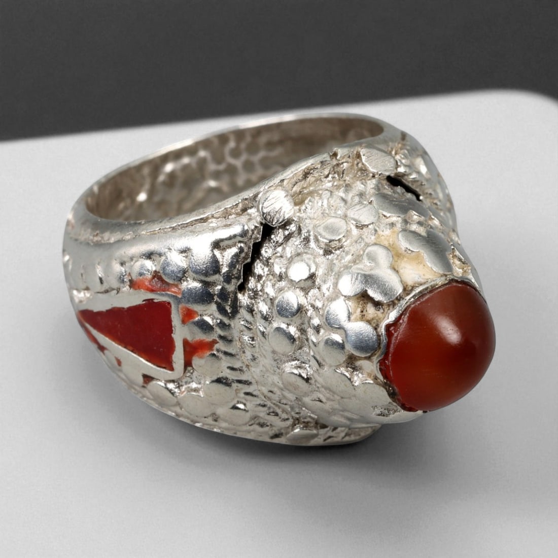 Antique Central Asian Tribal Carnelian and Red Enamel Silver Ring, c. 19th-20th Century, US Size 9: This powerful antique silver ring exemplifies the robust and symbolic artistry of Central Asian tribal jewelry, likely originating from the regions of Herat or northern Afghanistan. The design centers