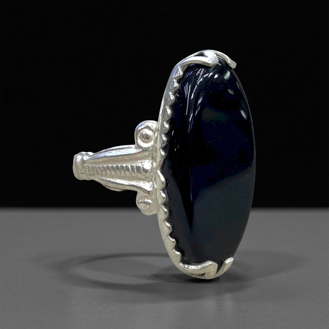 Vintage Persian Elongated Black Onyx Silver Ring, c. Mid-20th Century, Ring Size 9, 4.5g: This refined vintage silver ring, crafted in mid-20th-century Persia, exemplifies minimalist sophistication infused with traditional symbolism. At its center lies an elongated oval black onyx cabochon
