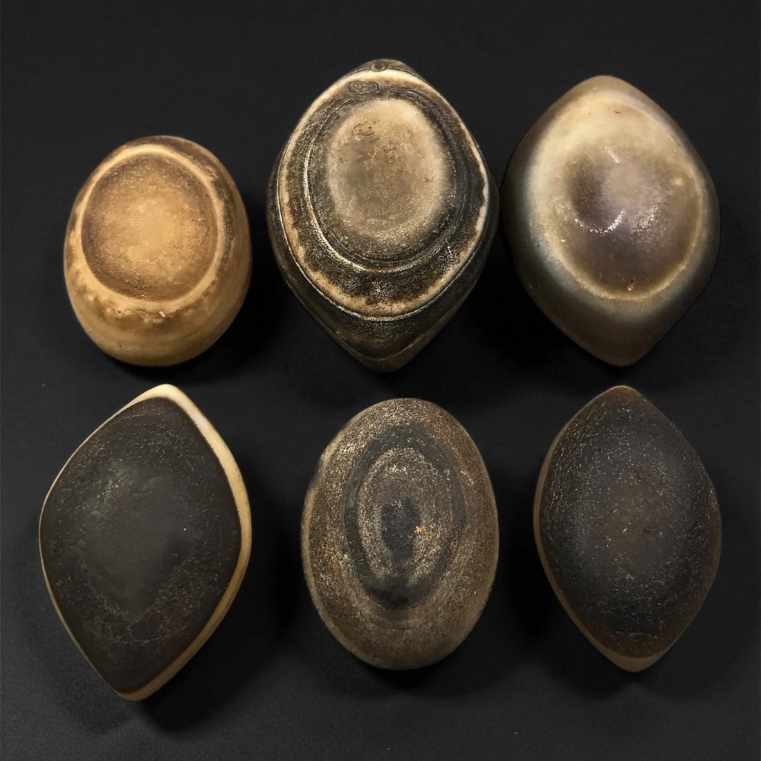 Ancient Medieval Tibetan Luk Mik "Goat's Eye" Agate Beads, c. 11th-14th Century CE, 2.2-3.2 cm: This striking collection of ancient medieval Luk Mik "Goat's Eye" agate beads dates to the 11th-14th century CE, during the late Tibetan Buddhist period influenced by the flourishing trade along the S