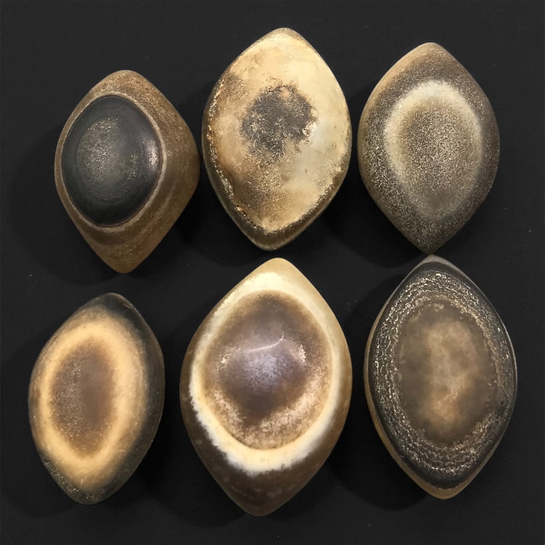 Ancient Medieval Tibetan Luk Mik "Goat's Eye" Agate Beads, c. 11th-14th Century CE, 2.3-2.9 cm: This striking collection of ancient medieval Luk Mik "Goat's Eye" agate beads dates to the 11th-14th century CE, during the late Tibetan Buddhist period influenced by the flourishing trade along the S