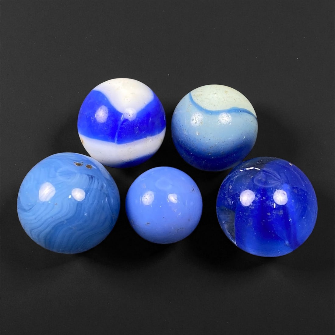 Vintage Glass Marbles Lot, Mid-20th Century, 1.2-1.6cm: This charming lot of vintage glass marbles, dating from the mid-20th century, reflects the artistry and playfulness of early handmade and molded glass craftsmanship. These marbles were produced during