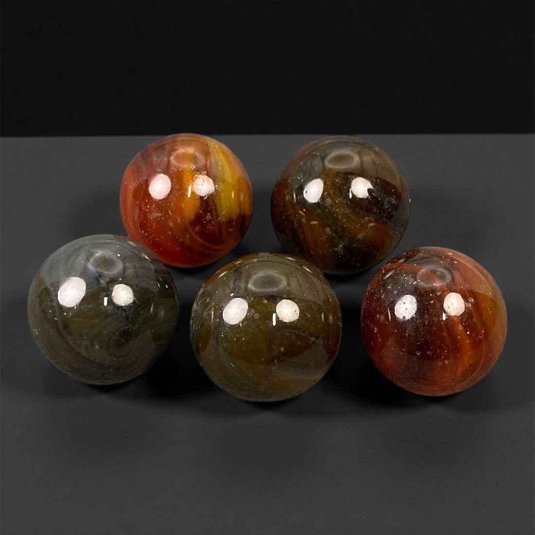 Vintage Glass Marbles Lot, Mid-20th Century, 1.5cm: This charming lot of vintage glass marbles, dating from the mid-20th century, reflects the artistry and playfulness of early handmade and molded glass craftsmanship. These marbles were produced during