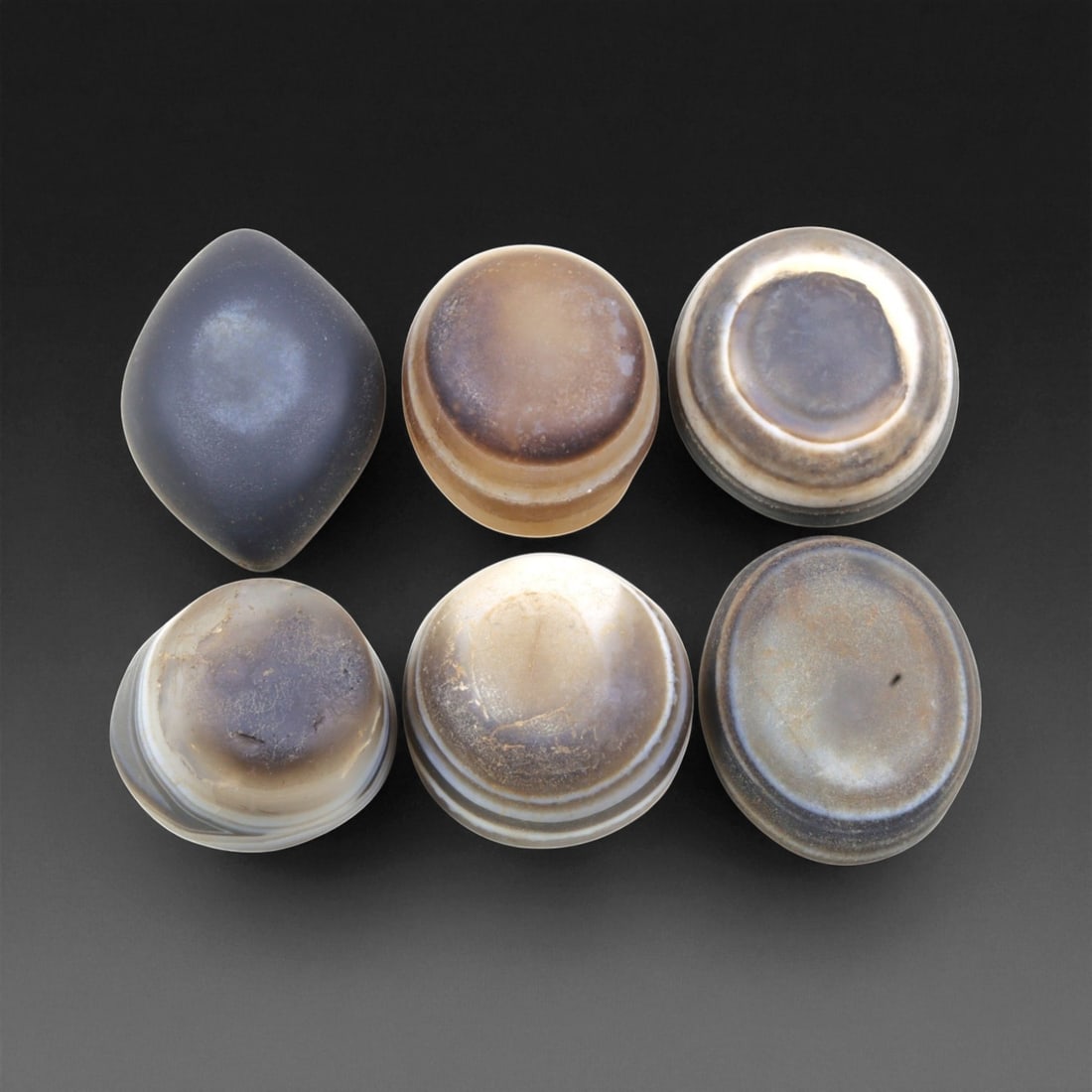 Ancient Medieval Tibetan Luk Mik "Goat's Eye" Agate Beads, c. 11th-14th Century CE, 2.2-2.5cm: This striking collection of ancient medieval Luk Mik "Goat's Eye" agate beads dates to the 11th-14th century CE, during the late Tibetan Buddhist period influenced by the flourishing trade along the S