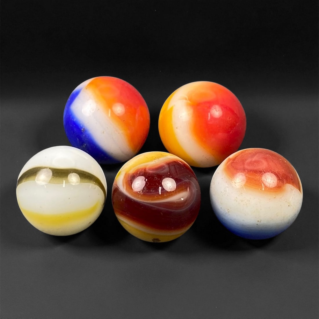Vintage Glass Marbles Lot, Mid-20th Century, 1.5-1.6cm: This charming lot of vintage glass marbles, dating from the mid-20th century, reflects the artistry and playfulness of early handmade and molded glass craftsmanship. These marbles were produced during