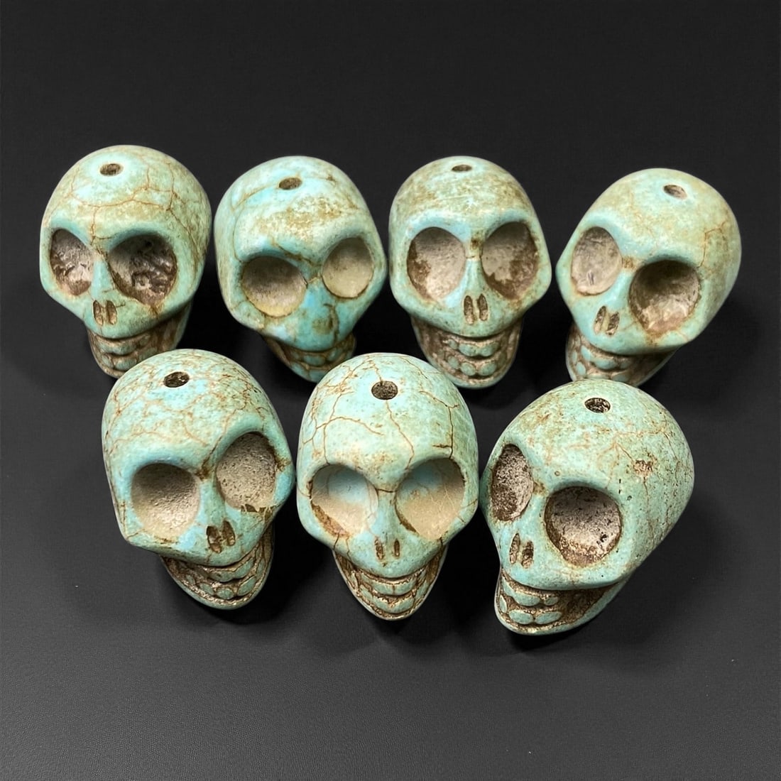 Vintage Tibetan Turquoise Skull Beads, c. Mid-20th Century, 1.7cm: This striking set of turquoise-carved skull beads, originates from Tibet and dates to the mid-20th century. Finely shaped and perforated for stringing, each bead represents a human skull, a motif rich