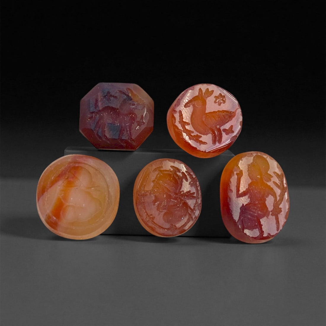 Ancient Sasanian Carnelian Intaglio Seals, c. 3rd-6th Century CE, 1.5 cm, 11 g: This refined set of five carnelian intaglio seals originates from the Sasanian Empire, the last great pre-Islamic Persian dynasty, celebrated for its sophisticated gem engraving and symbolic artistry.