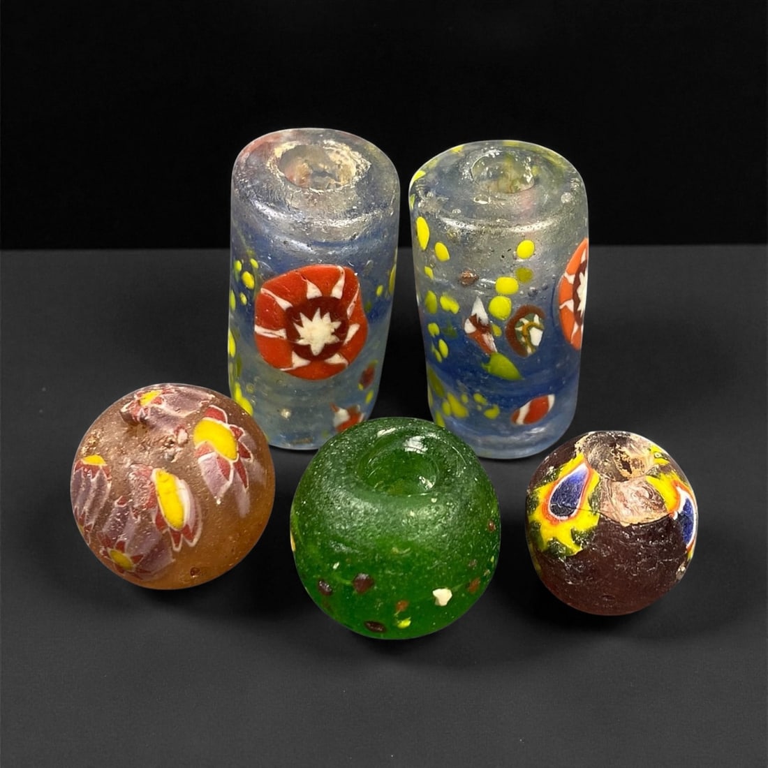 Antique Venetian Millefiori and Mosaic Glass Bead Group, c. 18th-19th Century, 1.2-2.6cm: This colorful assemblage of five antique glass beads showcases the remarkable artistry of Venetian glassmakers, whose mastery of millefiori and mosaic techniques made Venice a global center for luxury