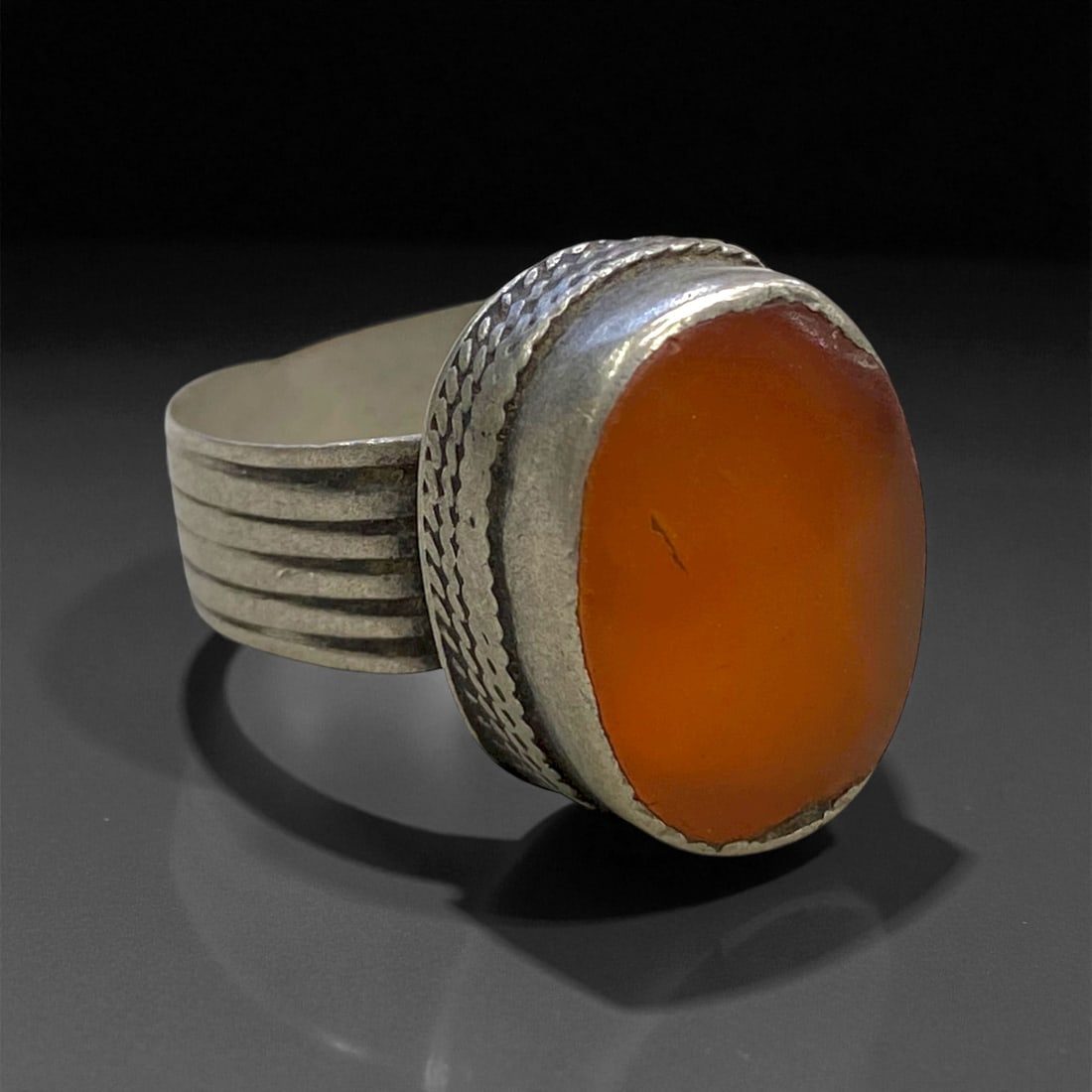 Antique Persian Carnelian Silver Ring, c. 19th-20th Century, US 10, 6g: This understated yet graceful antique Persian silver ring captures the quiet elegance of 19th to early 20th-century craftsmanship. The ring features an oval cabochon of warm orange carnelian, a stone 