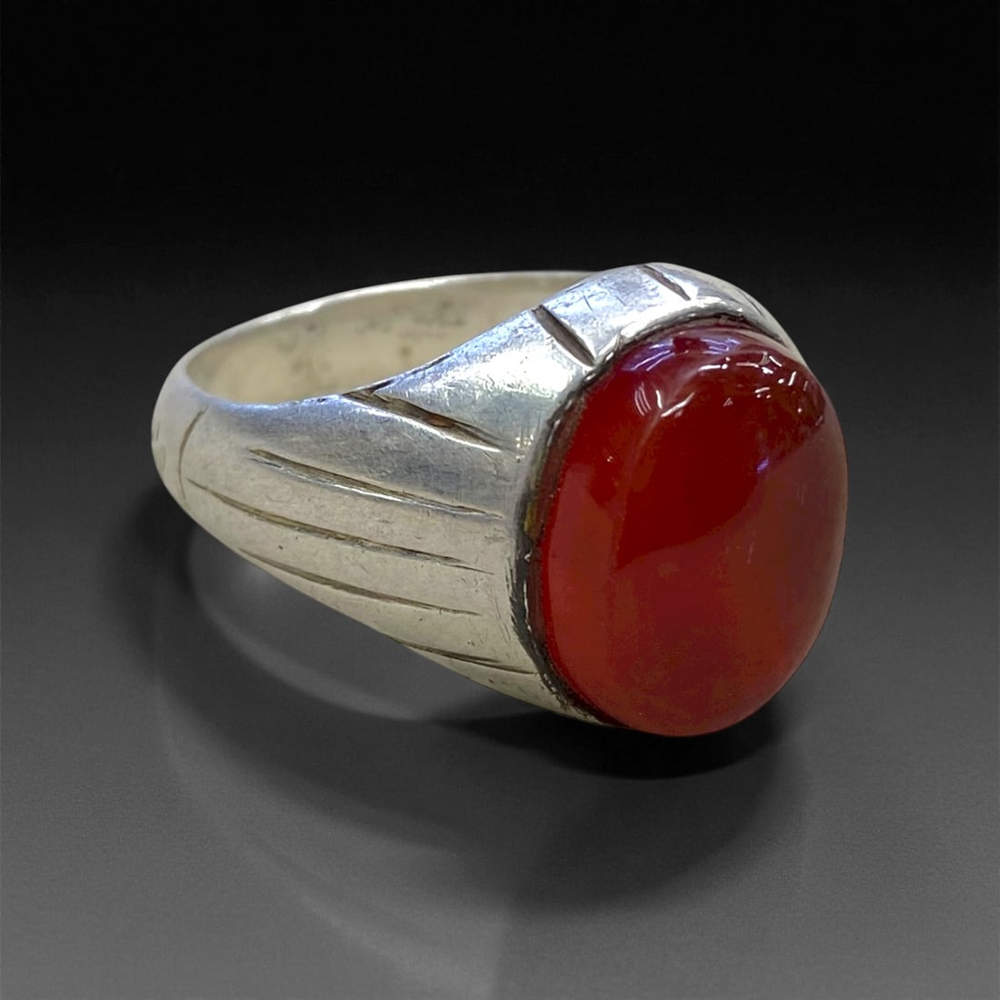 Antique Persian Carnelian Silver Ring, c. Early 20th Century, US 10.5, 8.5g: This elegant antique Persian silver ring showcases a radiant carnelian cabochon, richly hued in deep amber-red tones with natural translucence that glows warmly in the light. The stone, revered in Per