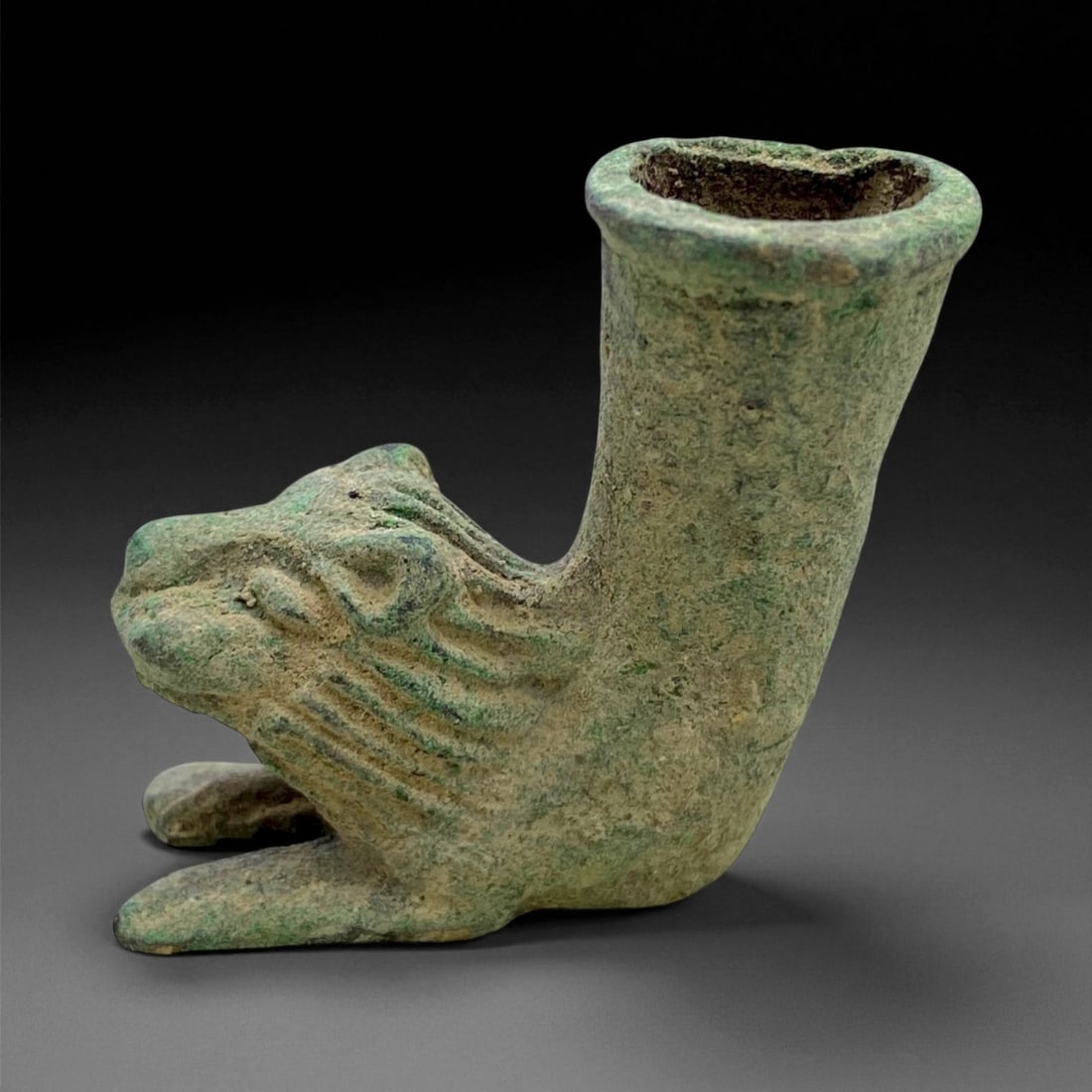 Ancient Achaemenid Bronze Lion-Head Rhyton Fragment, c. 5th-4th Century BCE, 4cm, 57g: This miniature bronze fragment, depicting a roaring lion with a cylindrical vessel rising from its back, originates from the Achaemenid Persian Empire, circa 5th-4th century BCE. The form represents a