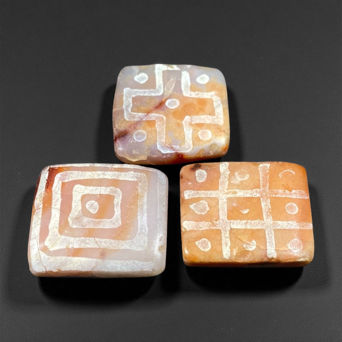 Ancient Medieval Silk Road Indo-Himalayan Etched Carnelian Beads, c. 8th-12th Century CE, 2.2-2.4cm: This elegant set of three etched carnelian beads originates from the Indo-Himalayan regions that flourished along the ancient Silk Road between the 8th and 12th centuries CE. Crafted from semi-translu