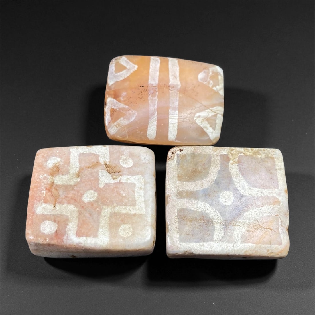 Ancient Medieval Silk Road Indo-Himalayan Etched Carnelian Beads, c. 8th-12th Century CE, 2.4-2.5cm: This elegant set of three etched carnelian beads originates from the Indo-Himalayan regions that flourished along the ancient Silk Road between the 8th and 12th centuries CE. Crafted from semi-translu